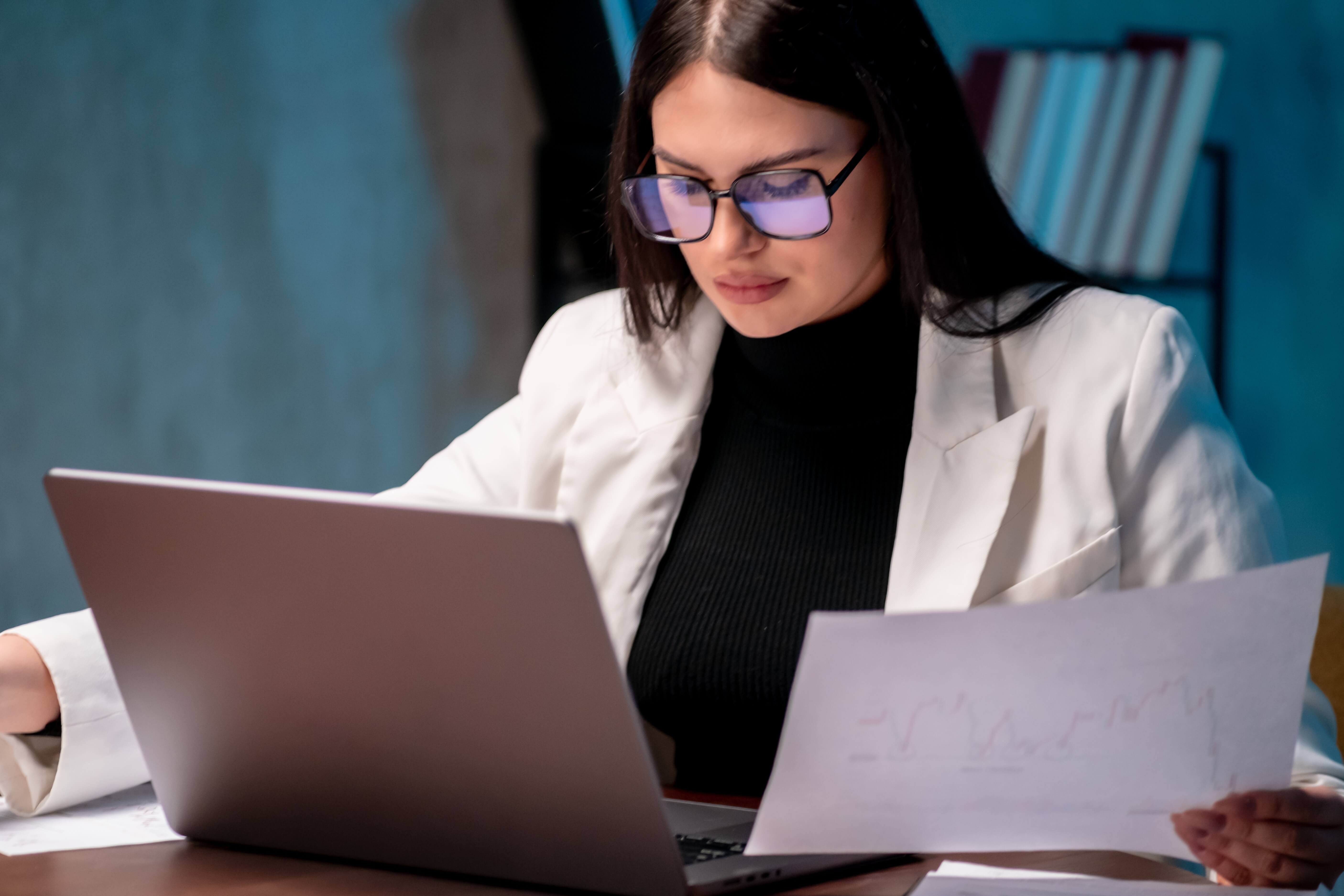 Female,Entrepreneur,Reviewing,Company,Performance,Metrics,At,Night.,Performance,Review